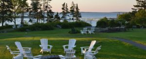 Adirondack chairs on the shore at a resort near Boothbay Harbor